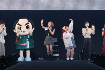 ステージ上で観音寺市をPRする銭形くんと出演者のみなさん