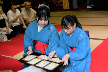 お茶席で和菓子を提供する女性2人