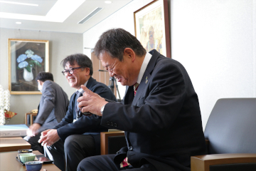 「瀬戸のおばあ物語」を試食し、笑顔を見せる佐伯市長